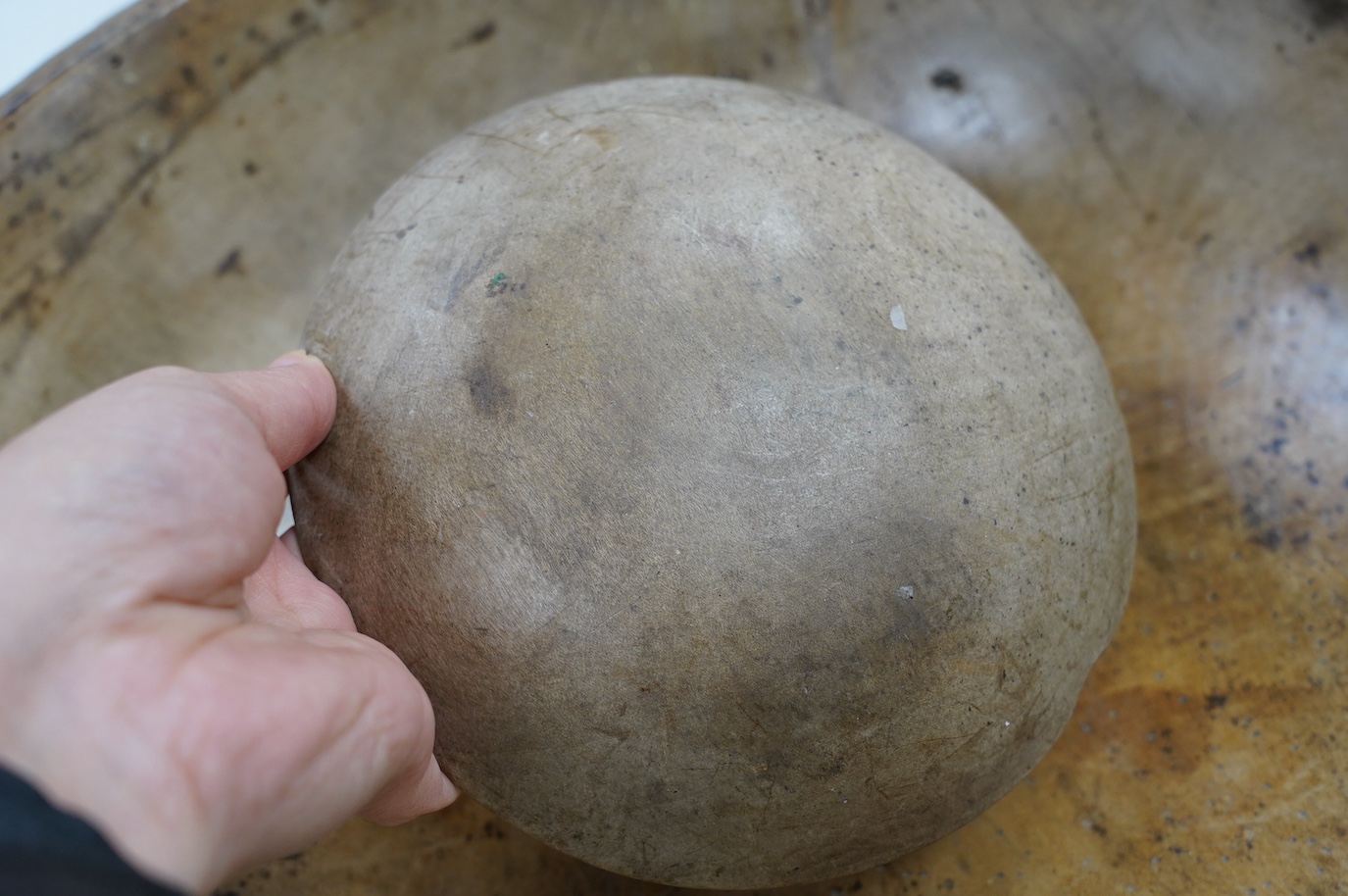 An 18th/19th century sycamore mixing bowl and a smaller bowl, largest 44cm diameter. Condition - poor